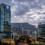 Standard Bank building and Capitec Bank building next to it for Standard Bank to Capitec Transfer Time: How Long Payments Take and What Can Cause Delays: SA Bank Fees
